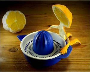 Suicide Squeeze pictured with a half lemon getting ready to place his head on a citrus juicer.